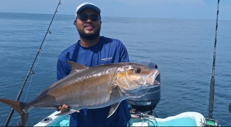 First Mate Pepe holding a tuna offshore in Tamarindo